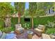 Serene brick patio with cozy seating and a mounted TV surrounded by lush greenery for outdoor enjoyment at 95 Ashley Ave # D, Charleston, SC 29401