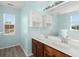 Bright bathroom featuring a double sink vanity, mirror, and view to a tub and window at 9731 Stockport Cir, Summerville, SC 29485