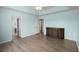 Bright bedroom with laminate flooring and a view to a doorway and a large cabinet at 9731 Stockport Cir, Summerville, SC 29485