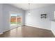 Bright dining area with sliding glass door to backyard, wood-look floors and modern lighting at 9731 Stockport Cir, Summerville, SC 29485