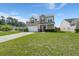 Charming two-story home featuring a well-maintained lawn and an attached two-car garage at 9731 Stockport Cir, Summerville, SC 29485