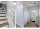 Bright hallway with wood floors, white staircase and trim, leading to an open-concept living space at 9731 Stockport Cir, Summerville, SC 29485