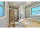 Updated bathroom with a glass-enclosed shower, travertine tile, and modern fixtures at 100 Lipman St, Summerville, SC 29483