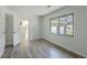A bright bedroom with wood-look floors and a view of the garage at 100 Lipman St, Summerville, SC 29483