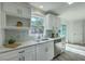 Modern kitchen with white cabinets, stainless steel appliances, and a marble tile backsplash at 100 Lipman St, Summerville, SC 29483