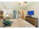Bright bedroom with neutral decor, a large TV, and access to an ensuite bathroom at 10032 Randall, McClellanville, SC 29458