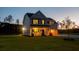 Inviting two-story home with a well-manicured lawn, porch, and garage at twilight at 10032 Randall, McClellanville, SC 29458