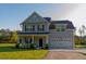 Charming two-story home with a well-maintained lawn and two car garage at 10032 Randall, McClellanville, SC 29458