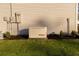 Exterior view of a house with a backup generator and green lawn at 10032 Randall, McClellanville, SC 29458