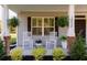 Inviting front porch with rocking chairs, and fresh greenery at 10032 Randall, McClellanville, SC 29458