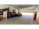 Spacious garage with storage, lawn mower, and view to the back yard at 10032 Randall, McClellanville, SC 29458