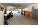 Spacious garage featuring a lawn mower, work bench, and storage solutions at 10032 Randall, McClellanville, SC 29458