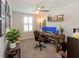 Functional home office with a large desk, dual monitors, and natural light at 10032 Randall, McClellanville, SC 29458