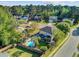 Aerial view showcasing the home's backyard oasis with a pool, seating area, and mature trees at 101 Writing Ct, Ladson, SC 29456