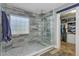 Bathroom features a glass shower, neutral tile and an entrance to a walk in closet at 101 Writing Ct, Ladson, SC 29456