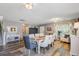 Bright dining room with modern lighting, seating for six, and neutral decor with light gray walls at 101 Writing Ct, Ladson, SC 29456