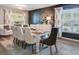 Dining room with a large wooden table, elegant chairs, and a modern accent wall at 101 Writing Ct, Ladson, SC 29456