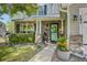 Inviting front porch with brick accents, decorative plants, and a well-maintained garden at 101 Writing Ct, Ladson, SC 29456