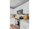 Bright kitchen features white cabinets, stainless steel appliances, and marble countertops at 101 Writing Ct, Ladson, SC 29456