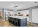 Kitchen island with white countertops, bar seating, stainless steel appliances and shaker style cabinets at 101 Writing Ct, Ladson, SC 29456
