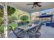 Covered outdoor patio features a dining area, ceiling fan, and backyard views for relaxation and entertainment at 101 Writing Ct, Ladson, SC 29456