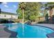 Private pool surrounded by palm trees creates a tropical paradise in this backyard retreat at 101 Writing Ct, Ladson, SC 29456