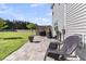 Relaxing back patio with paved flooring, outdoor seating, and a lush green lawn at 106 Lakelyn Rd, Moncks Corner, SC 29461