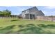 Large fenced backyard with a screened porch, lawn, and mature trees at 106 Lakelyn Rd, Moncks Corner, SC 29461