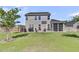 Well-maintained backyard featuring a patio, grill, screened porch and lush greenery at 106 Lakelyn Rd, Moncks Corner, SC 29461