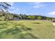 Expansive backyard featuring lush green lawn, wooden fence, mature trees, and a storage shed at 106 Lakelyn Rd, Moncks Corner, SC 29461