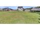 Large, fenced backyard with lush green grass and the home's exterior in the background at 106 Lakelyn Rd, Moncks Corner, SC 29461
