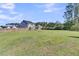 Expansive backyard with lush grass, fenced perimeter, and a clear view of the home's exterior at 106 Lakelyn Rd, Moncks Corner, SC 29461
