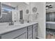 A clean and bright bathroom has double sinks, gray cabinetry, and a glass-enclosed shower at 106 Lakelyn Rd, Moncks Corner, SC 29461