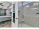 Modern tiled shower with seat and glass door adjacent to bedroom with gray barn door and patterned rug at 106 Lakelyn Rd, Moncks Corner, SC 29461