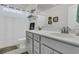 Bathroom with double vanity, gray cabinets, and shower with white curtain at 106 Lakelyn Rd, Moncks Corner, SC 29461