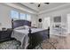 A primary bedroom features a dark wood bed frame, tray ceilings, and three windows providing natural light at 106 Lakelyn Rd, Moncks Corner, SC 29461