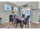Elegant dining room with chandelier and table set for four next to glass sliding doors at 106 Lakelyn Rd, Moncks Corner, SC 29461