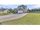 Charming home exterior featuring a two-car garage, concrete driveway, and well-manicured lawn at 106 Lakelyn Rd, Moncks Corner, SC 29461