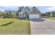 Charming two-story home featuring stone accents, a well-manicured lawn, and an attached two-car garage at 106 Lakelyn Rd, Moncks Corner, SC 29461