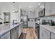 Updated kitchen boasts gray cabinets, stainless steel appliances, and large granite countertops at 106 Lakelyn Rd, Moncks Corner, SC 29461