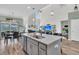 A well-appointed kitchen features modern appliances, gray cabinets, and an island with bar seating and a stainless sink at 106 Lakelyn Rd, Moncks Corner, SC 29461