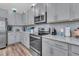 Close-up of stainless oven and gray cabinets with granite countertops in a modern kitchen at 106 Lakelyn Rd, Moncks Corner, SC 29461