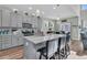 Modern kitchen features gray cabinets, stainless appliances, and a large island with seating at 106 Lakelyn Rd, Moncks Corner, SC 29461