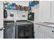 A functional laundry room offers a gray washer and dryer set, wire shelving, storage, and a white countertop at 106 Lakelyn Rd, Moncks Corner, SC 29461