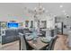 A bright and open living space is defined by wood flooring, a large sectional couch, and sight lines to the kitchen at 106 Lakelyn Rd, Moncks Corner, SC 29461