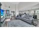 Spacious living room with gray sofa and seating offers an open floor plan to the kitchen at 106 Lakelyn Rd, Moncks Corner, SC 29461