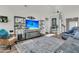 Cozy living room features stylish shelving with decor and a large screen TV for entertainment at 106 Lakelyn Rd, Moncks Corner, SC 29461