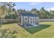 Backyard shed featuring a ramped entrance, double doors, and tidy gravel landscaping at 106 Lakelyn Rd, Moncks Corner, SC 29461