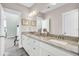 Bright bathroom featuring double sinks with granite countertop and white cabinets at 1063 Hills Plantation Dr, Charleston, SC 29412