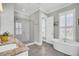 Bright bathroom featuring a soaking tub, glass shower, and granite countertops at 1063 Hills Plantation Dr, Charleston, SC 29412